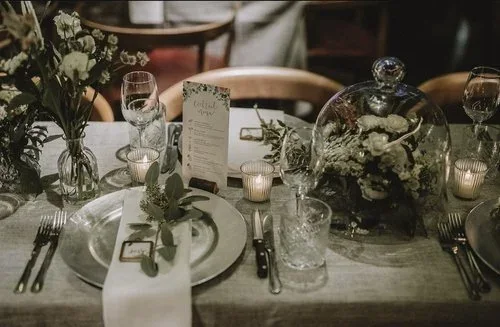 Candlelit dinner place setting with delicate white flowers