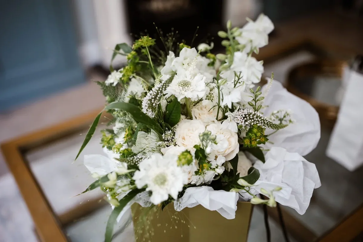 White bridal bouquet with roses and trailing foliage