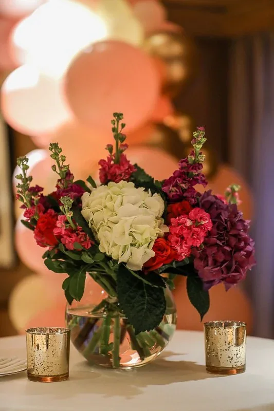 Compact jewel-toned event arrangement with candles