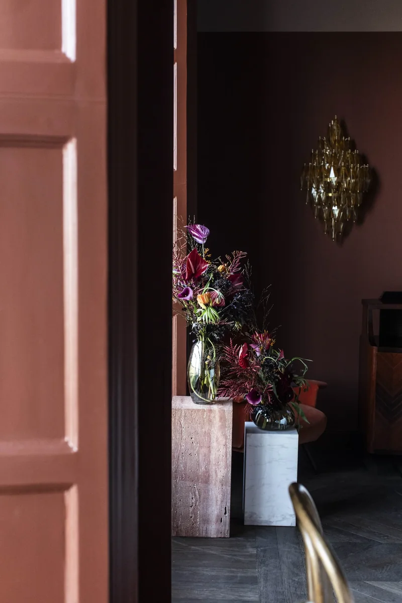 Tall floral arrangement in an intimate private dining room