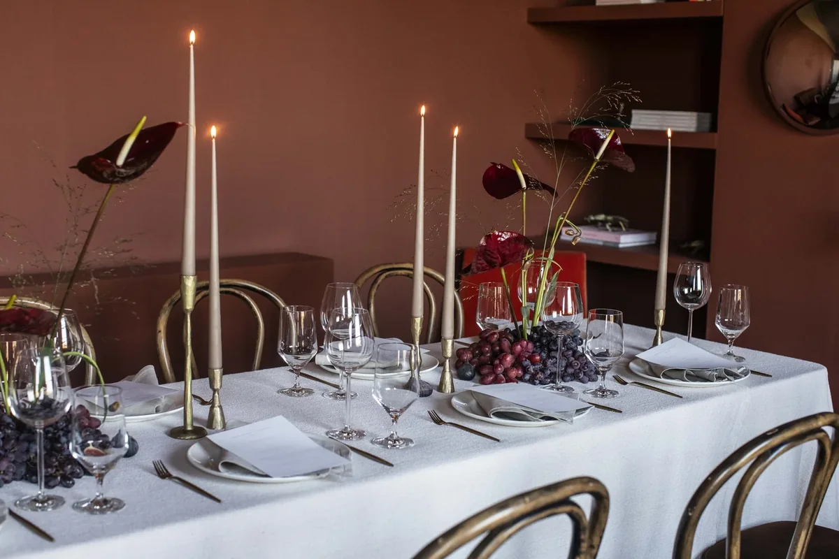 Long table styled with sculptural flowers and slender candles