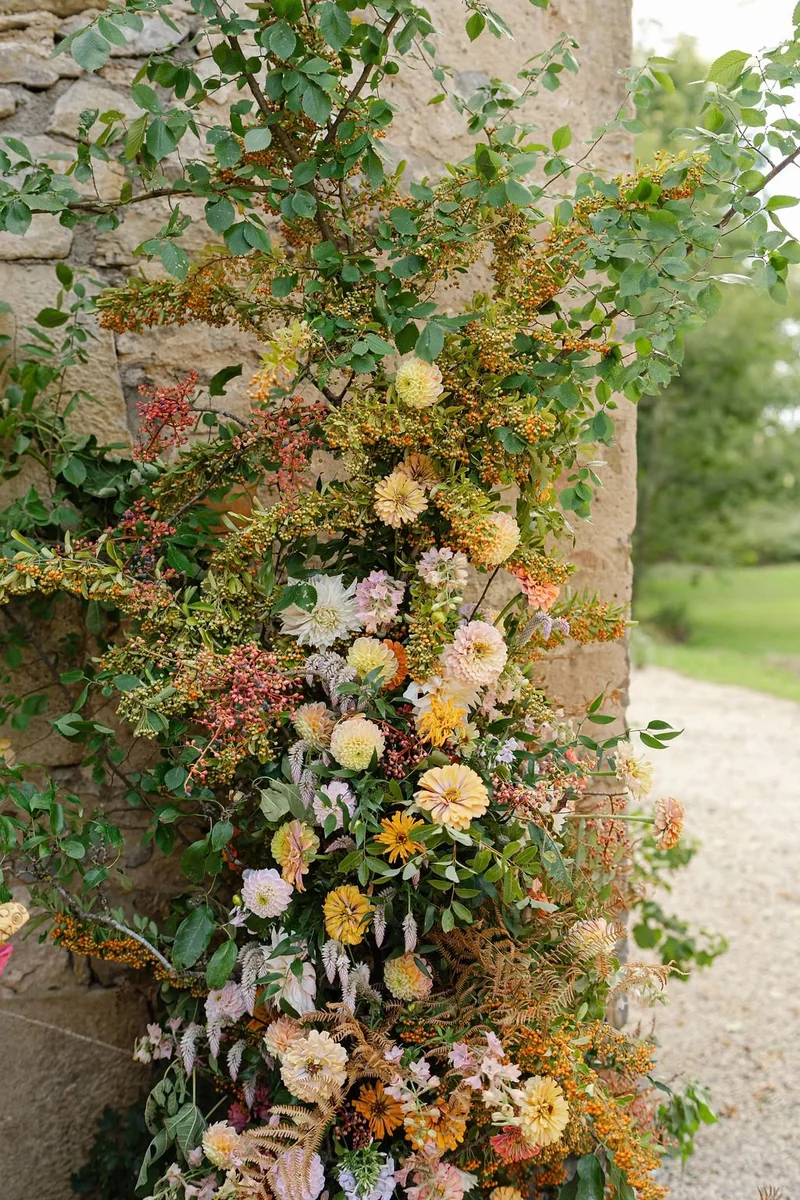Abundant seasonal flowers climbing a stone wall