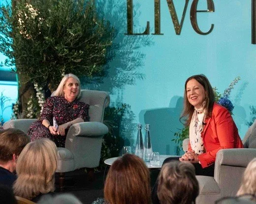 Panel discussion staged against a foliage and flower backdrop