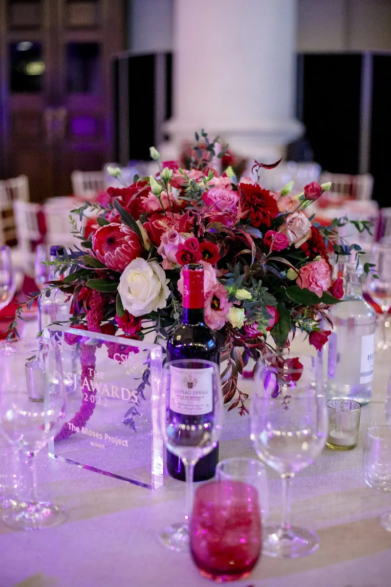 Pink floral centrepiece with event place settings