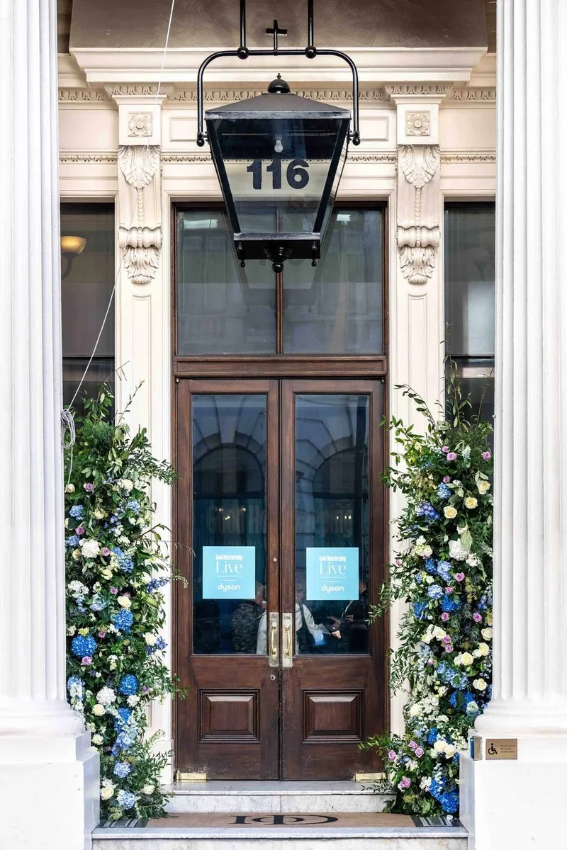 Blue and white floral installation framing a London doorway