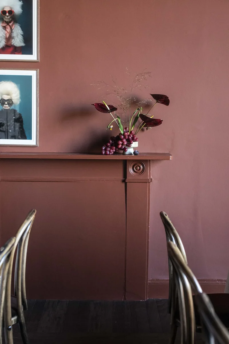 Small seasonal arrangement on a private dining room mantel