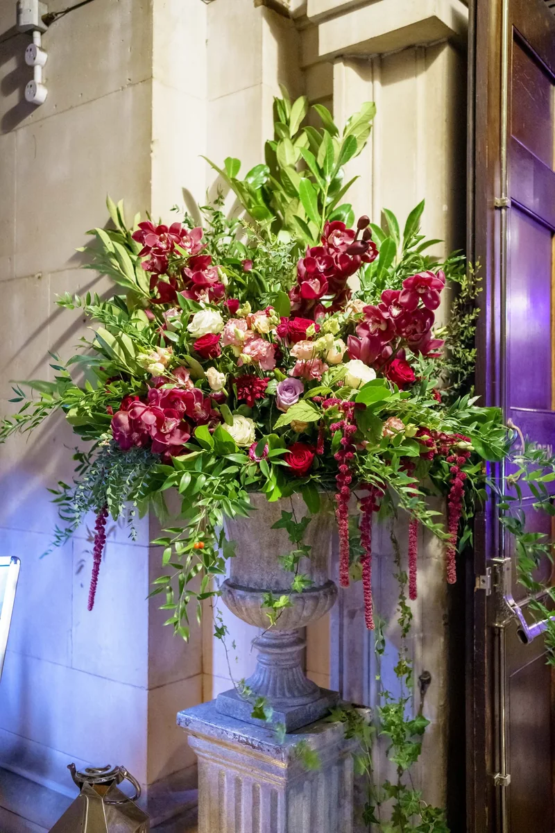 Large pink and green urn arrangement at an awards dinner