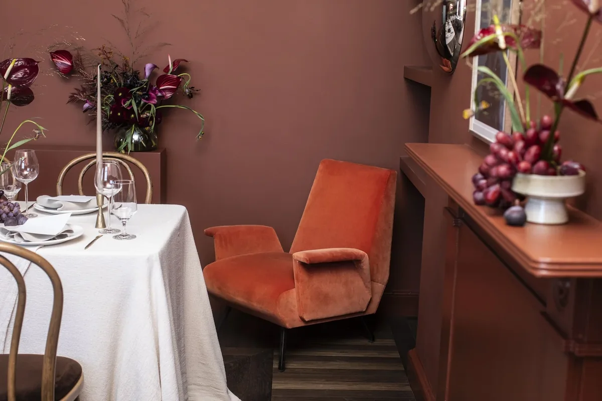 Colourful seasonal arrangement beside a private dining table