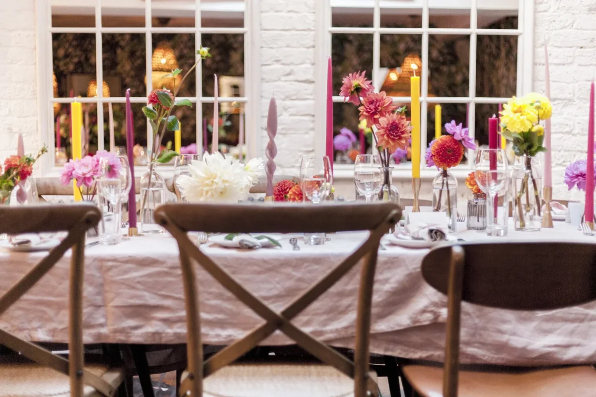 Celebration table dressed with vivid seasonal flowers