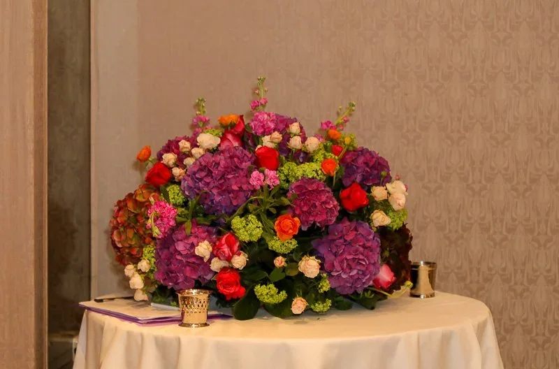 Large colourful floral arrangement at an event reception