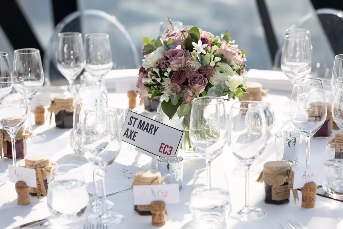 Pastel wedding table flowers with a city street table name