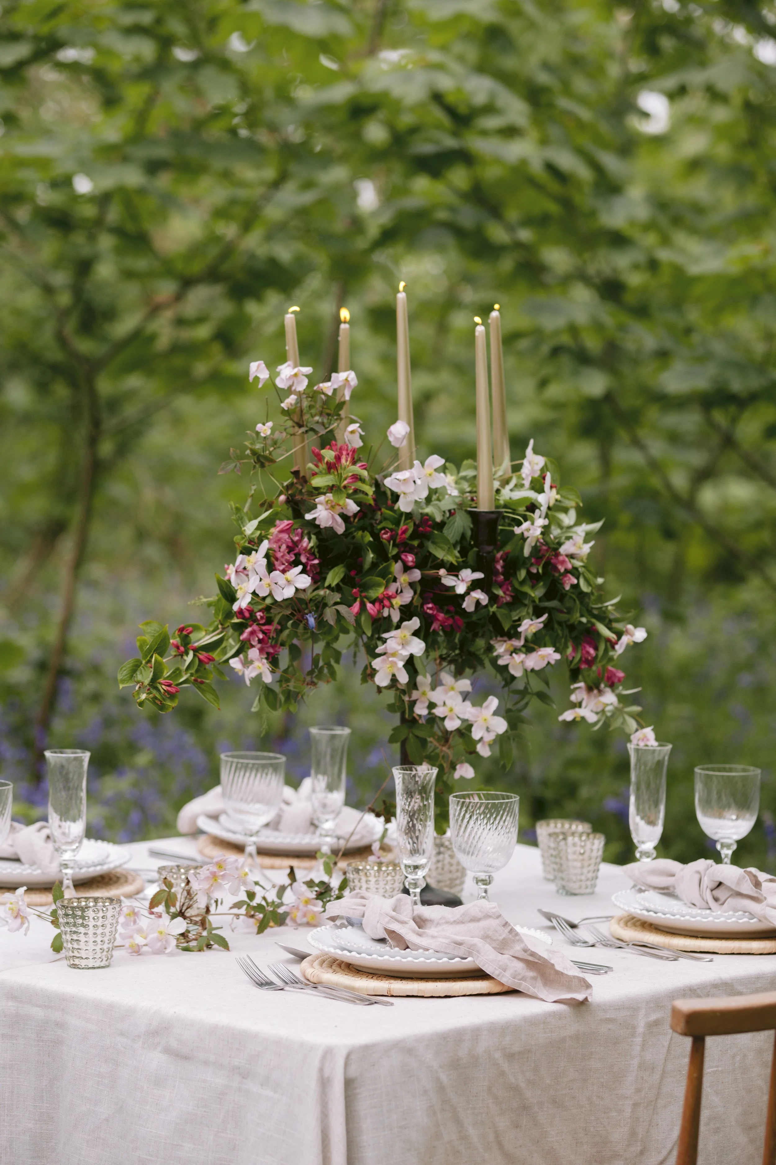 Candlelit outdoor table with romantic seasonal flowers