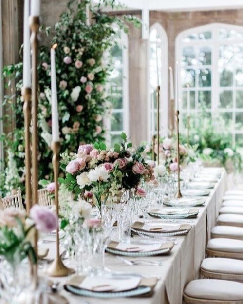 Candlelit London event table with low seasonal floral arrangements