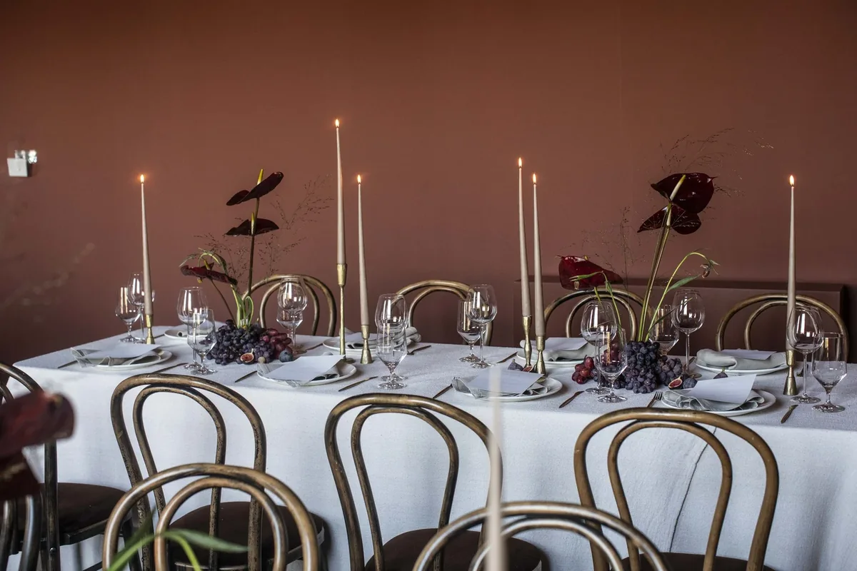 Private dinner setting with sculptural flowers and candles