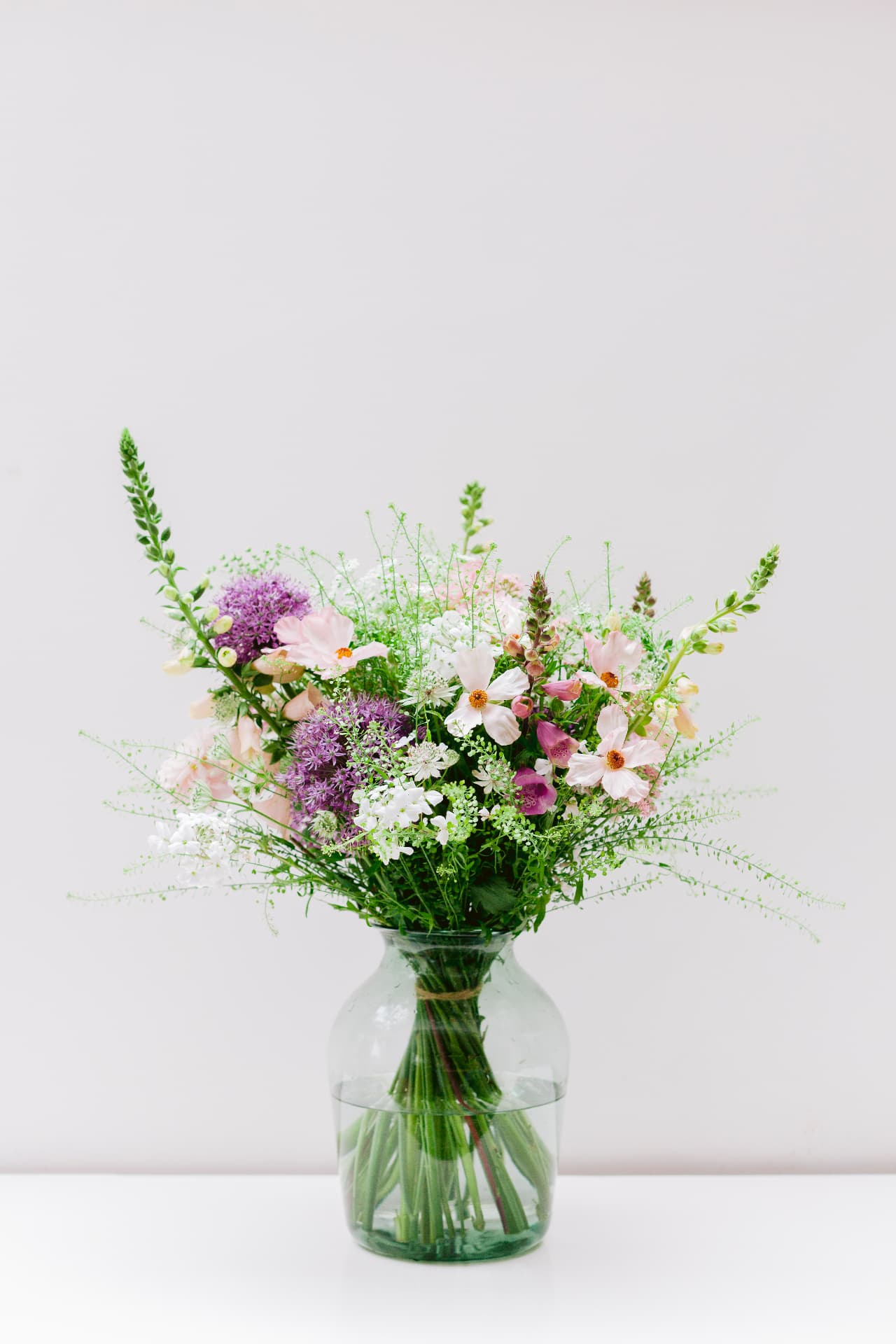 Seasonal Bramble & Willow bouquet of cosmos, alliums and foxgloves in a glass vase