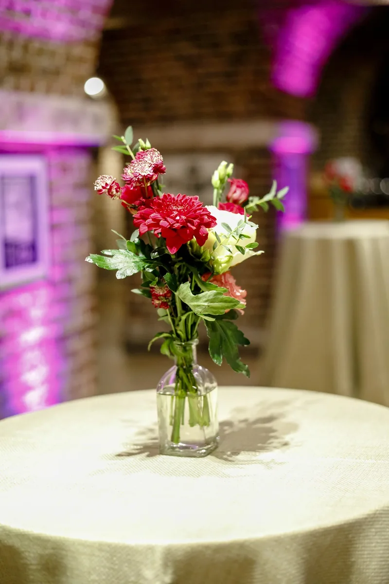 Small red and white floral arrangement on a cocktail table