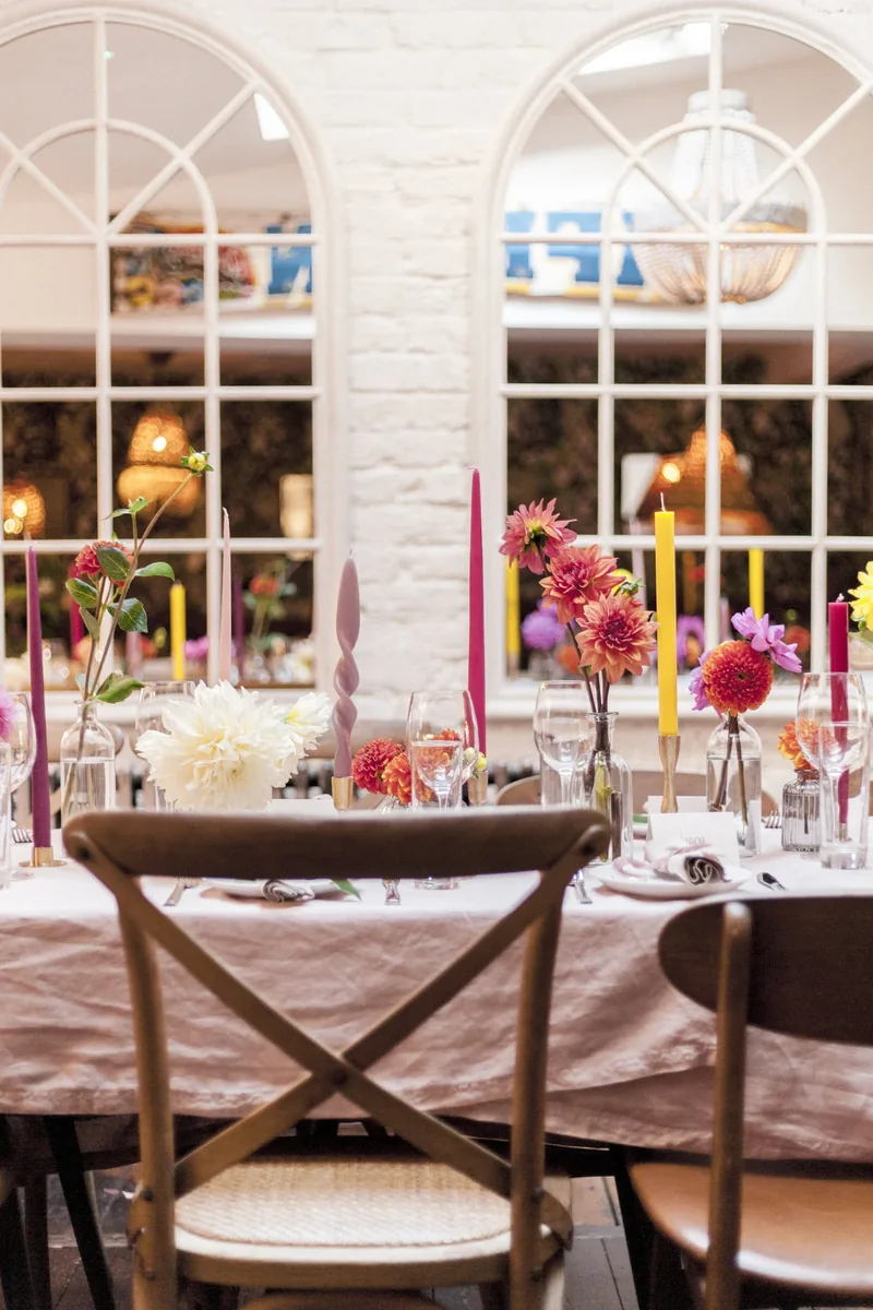 Colourful event tables viewed through arched windows