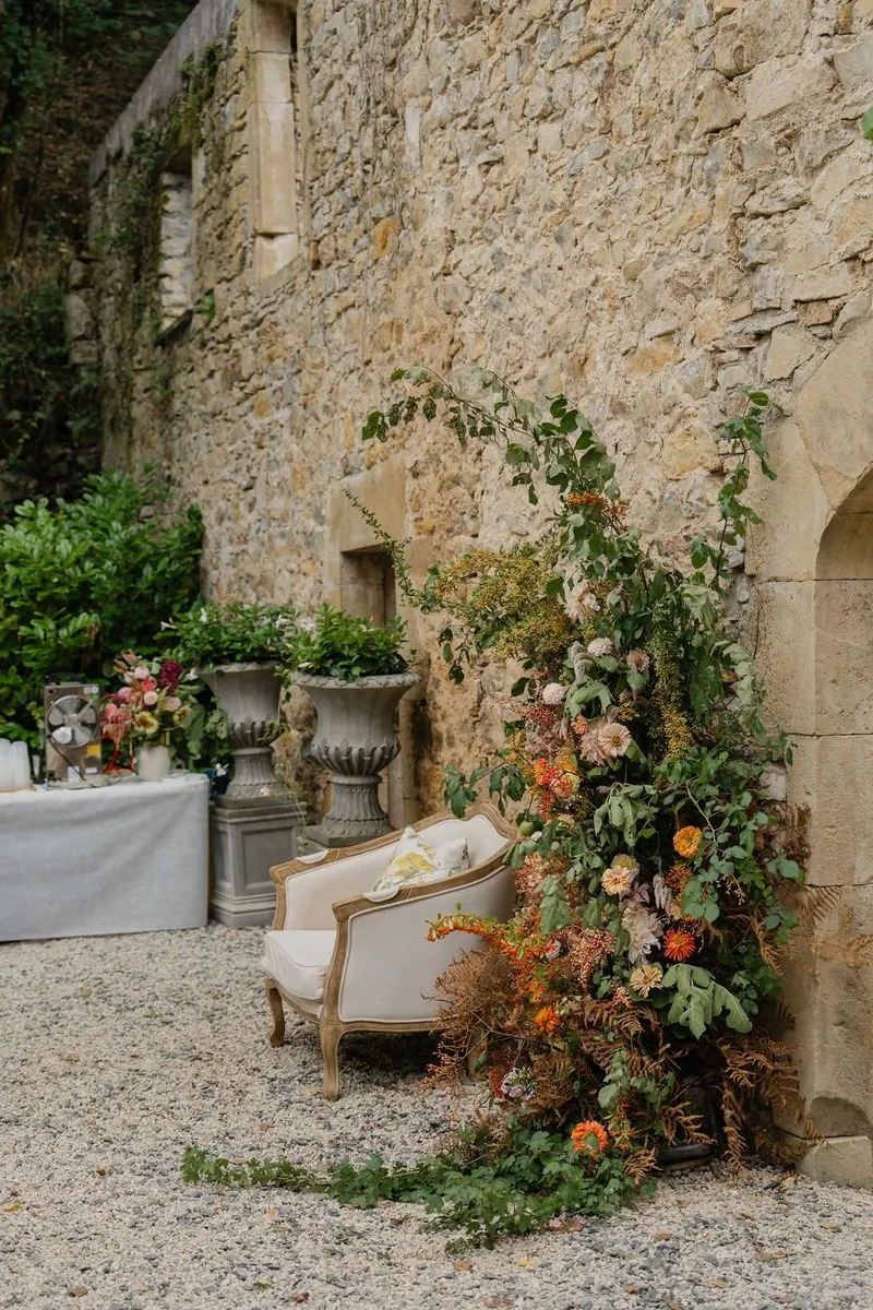 Seasonal floral installation against a stone wall